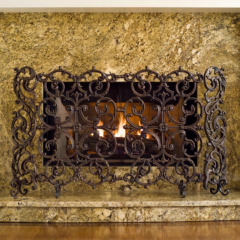 Relax in front of a cozy fire with the flames dancing behind our Classic Two-panel Iron Fireplace Screen. The hinged sides adjust from 48-58